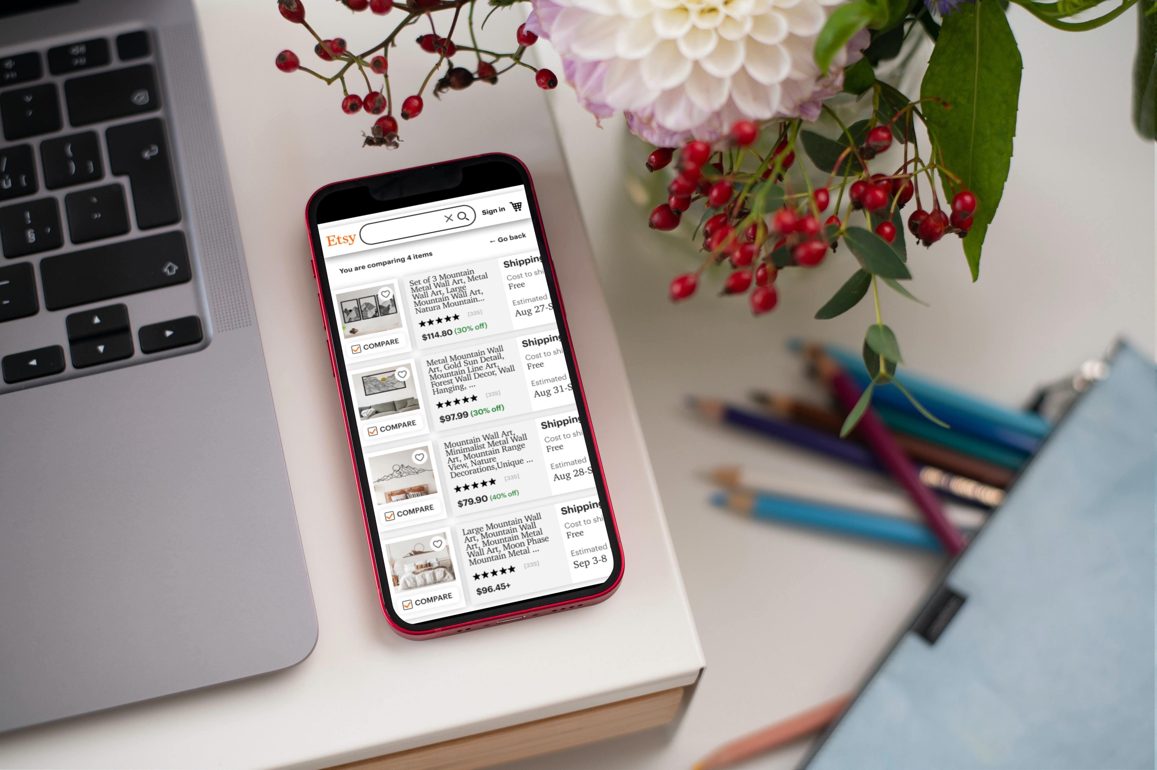 Etsy comparison screen on mockup of iphone on a desk